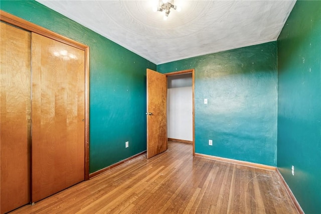 308 Cypress St, Rostraver, PA 15089 - unfurnished bedroom featuring wood finished floors, baseboards, and a closet