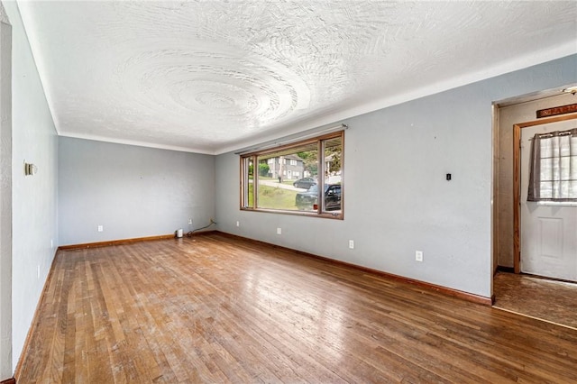 308 Cypress St, Rostraver, PA 15089 - spare room featuring a textured ceiling, wood finished floors, and baseboards
