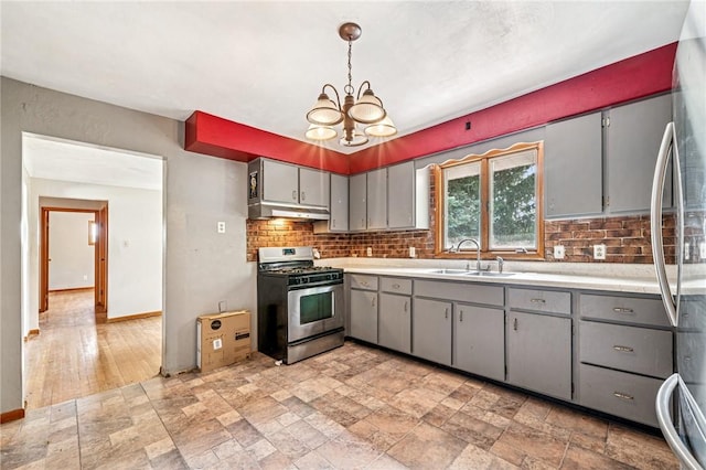 308 Cypress St, Rostraver, PA 15089 - kitchen featuring appliances with stainless steel finishes, gray cabinetry, a sink, and under cabinet range hood