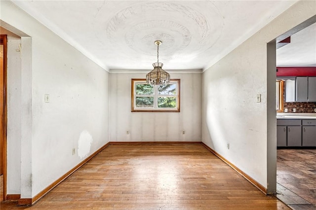 308 Cypress St, Rostraver, PA 15089 - unfurnished dining area featuring light wood finished floors, a chandelier, and baseboards