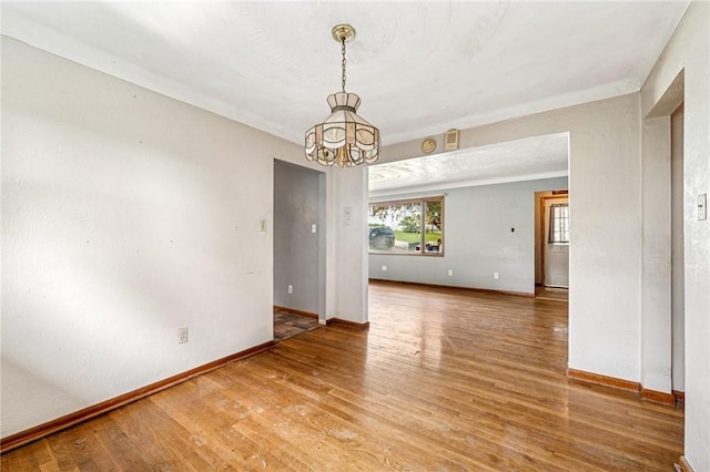 308 Cypress St, Rostraver, PA 15089 - spare room featuring a chandelier, baseboards, and wood finished floors