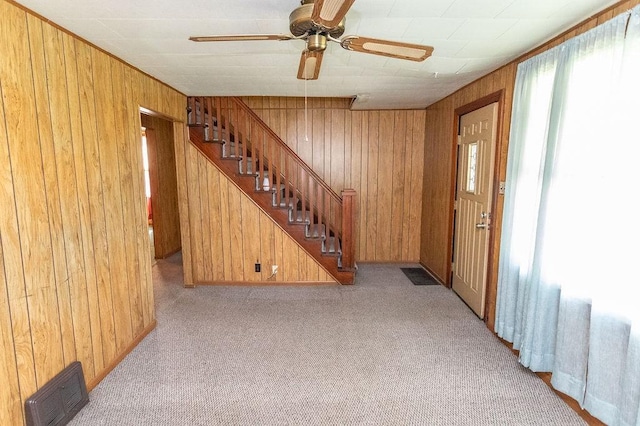508 Meadow St, North Union Twp, PA 15401 - unfurnished living room featuring wood walls, stairs, carpet floors, and ceiling fan