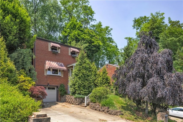 2389 High Oak Dr, Banksville/Westwood, PA 15220 - view of side of property featuring brick siding, a garage, and driveway