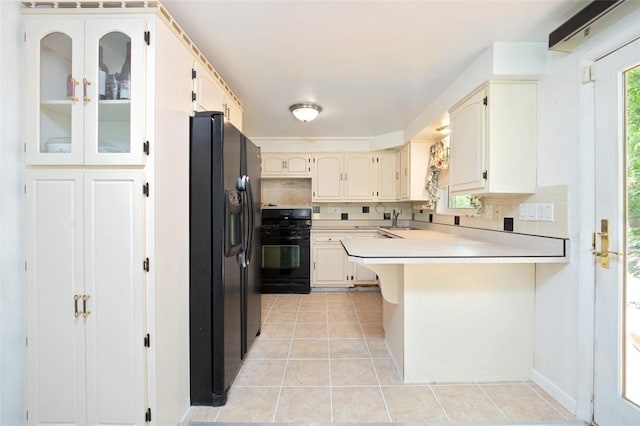 504 N St, Baldwin Boro, PA 15227 - kitchen featuring gas range, black fridge with ice dispenser, a peninsula, a sink, and light tile patterned floors