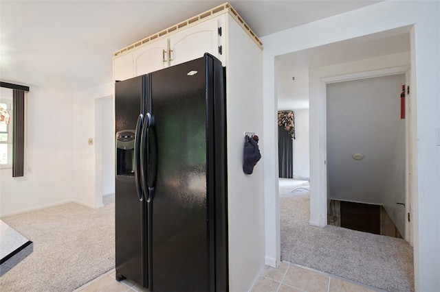 504 N St, Baldwin Boro, PA 15227 - kitchen with black fridge with ice dispenser, light carpet, white cabinets, and baseboards