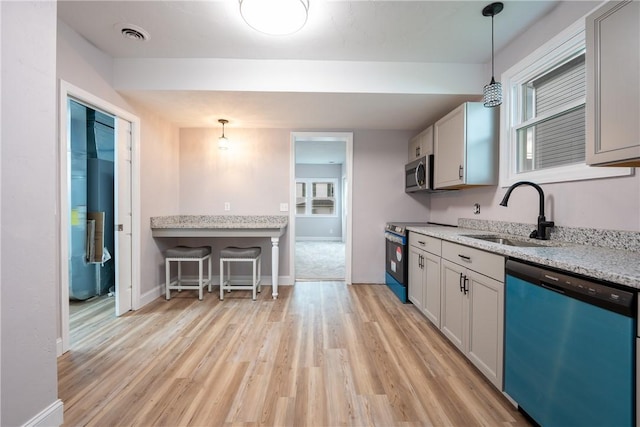 1200 Wood St, Derry Twp, PA 15650 - kitchen with stainless steel appliances, a sink, light wood-style floors, and hanging light fixtures