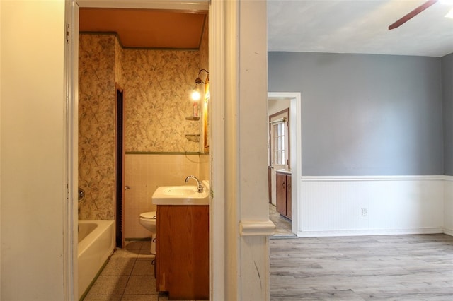 202 Jane St, Mckees Rocks, PA 15136 - bathroom with vanity, wainscoting, toilet, ceiling fan, and wood finished floors