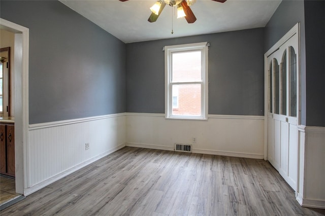 202 Jane St, Mckees Rocks, PA 15136 - unfurnished bedroom with wood finished floors, a wainscoted wall, and ceiling fan