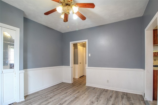 202 Jane St, Mckees Rocks, PA 15136 - empty room with a ceiling fan, wainscoting, and wood finished floors
