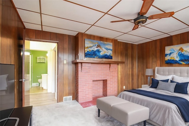 202 Jane St, Mckees Rocks, PA 15136 - carpeted bedroom featuring wooden walls, a brick fireplace, and a ceiling fan