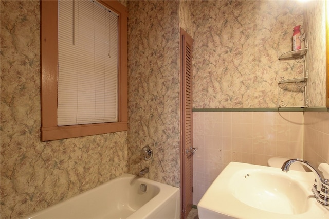 202 Jane St, Mckees Rocks, PA 15136 - bathroom with wallpapered walls, a bath, a sink, and wainscoting