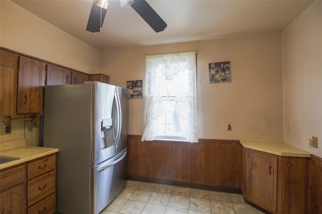 202 Jane St, Mckees Rocks, PA 15136 - kitchen featuring stainless steel fridge, a wainscoted wall, brown cabinetry, a ceiling fan, and light countertops