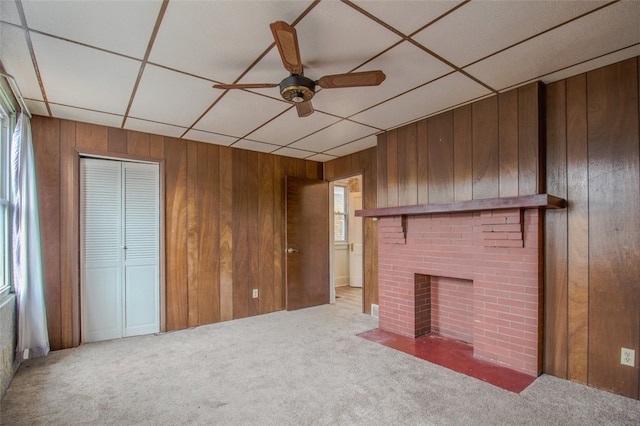 202 Jane St, Mckees Rocks, PA 15136 - unfurnished living room with wooden walls, carpet, a ceiling fan, a brick fireplace, and a paneled ceiling
