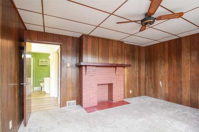 202 Jane St, Mckees Rocks, PA 15136 - unfurnished living room with wood walls, a ceiling fan, carpet, and a brick fireplace