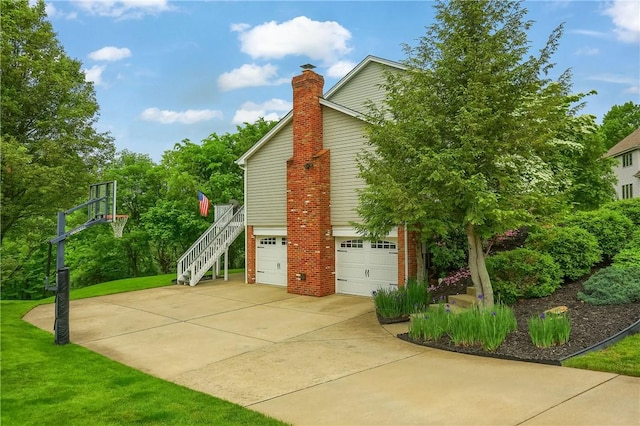 814 Graywyck Dr, Seven Fields Boro, PA 16046 - view of side of home featuring an attached garage, a chimney, brick siding, stairway, and concrete driveway