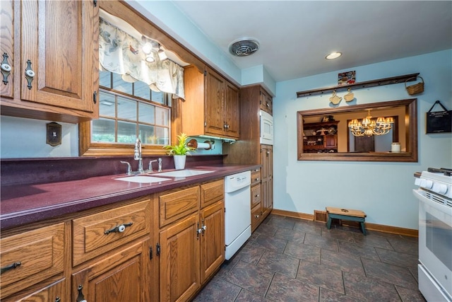 322 Franklin Dr, Peters Twp, PA 15241 - kitchen featuring white appliances, a sink, dark countertops, stone tile floors, and brown cabinets