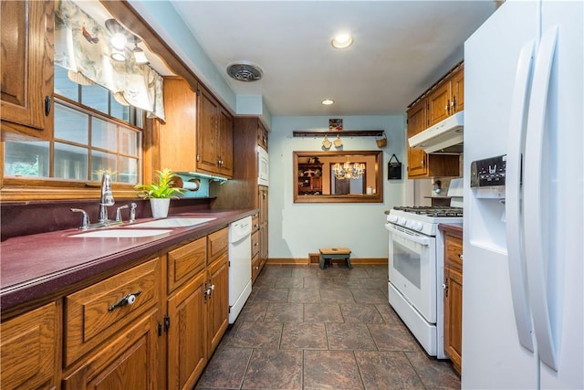 322 Franklin Dr, Peters Twp, PA 15241 - kitchen with white appliances, under cabinet range hood, stone tile floors, a sink, and dark countertops