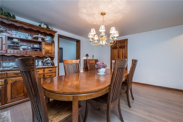 322 Franklin Dr, Peters Twp, PA 15241 - dining area with a chandelier, light wood-style floors, and baseboards