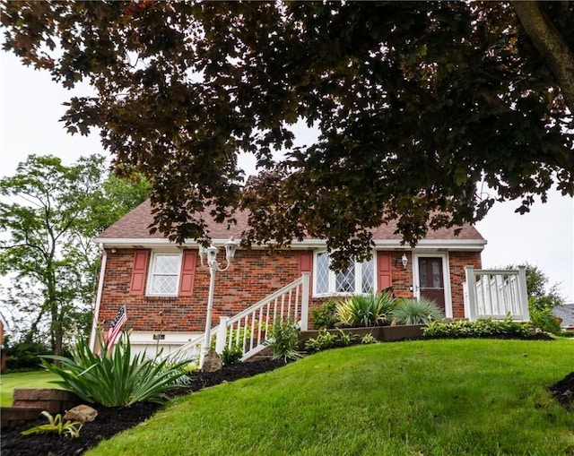 10 Claireview Dr, Scott Twp Sal, PA 15106 - view of front facade with a front lawn, brick siding, a garage, and roof with shingles