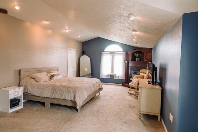 10 Claireview Dr, Scott Twp Sal, PA 15106 - bedroom featuring lofted ceiling, light colored carpet, a glass covered fireplace, a textured ceiling, and baseboards