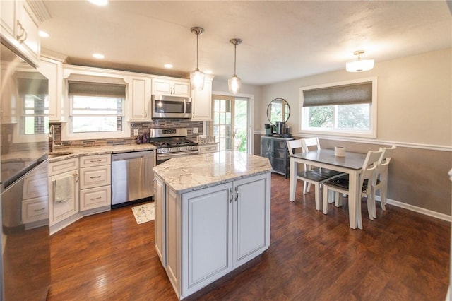10 Claireview Dr, Scott Twp Sal, PA 15106 - kitchen with stainless steel appliances, a center island, backsplash, light stone countertops, and dark wood finished floors