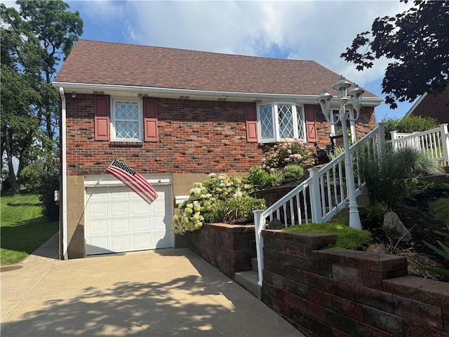 10 Claireview Dr, Carnegie, PA 15106 - view of front of home featuring driveway, brick siding, an attached garage, and a shingled roof