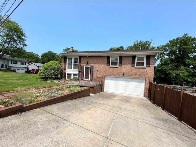 501 Clarendon St, Ohara, PA 15238 - bi-level home with brick siding, driveway, an attached garage, a vegetable garden, and a chimney