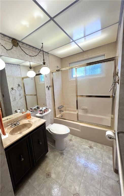 501 Clarendon St, Ohara, PA 15238 - bathroom with vanity, shower / bath combination, toilet, and tile patterned floors