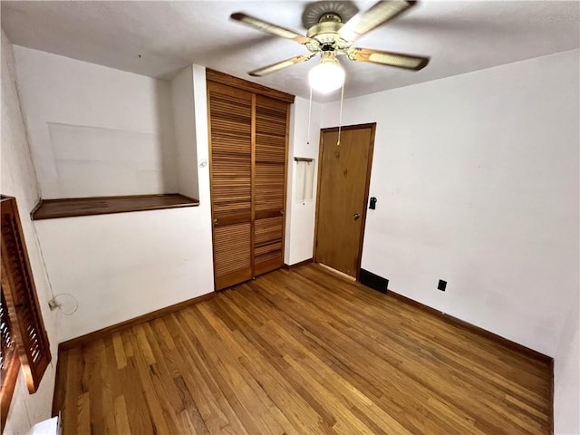 501 Clarendon St, Ohara, PA 15238 - unfurnished bedroom with a closet, baseboards, wood finished floors, and a ceiling fan