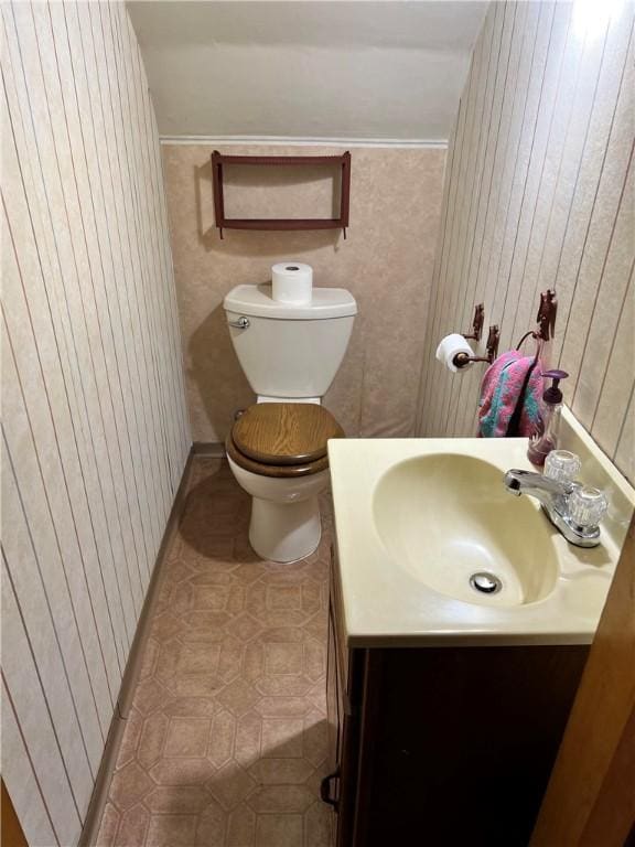501 Clarendon St, Ohara, PA 15238 - half bathroom with vanity, toilet, tile patterned flooring, and wooden walls