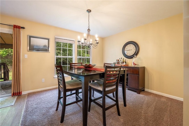 113 Unity Sq, Unity Twp, PA 15601 - carpeted dining space with a chandelier, baseboards, and wood finished floors