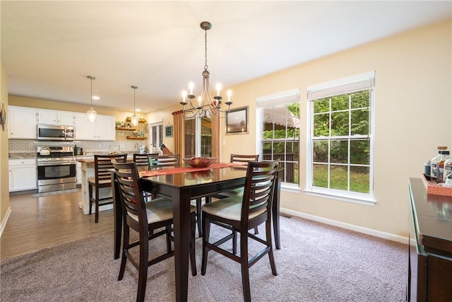 113 Unity Sq, Unity Twp, PA 15601 - carpeted dining area featuring a chandelier, plenty of natural light, and baseboards