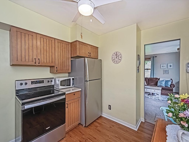 118 Judith Dr, Peters Twp, PA 15367 - kitchen featuring stainless steel appliances, light wood-style flooring, ceiling fan, light countertops, and brown cabinets