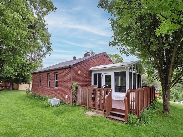 118 Judith Dr, Peters Twp, PA 15367 - rear view of house featuring a sunroom, a wooden deck, brick siding, and a yard
