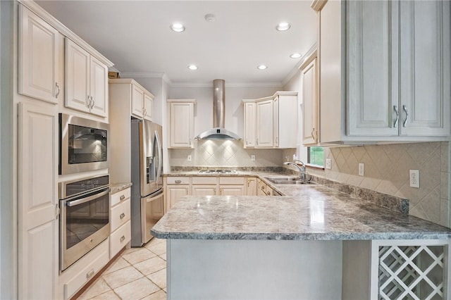 120 Canterbury Ln, Peters Twp, PA 15317 - kitchen with stainless steel appliances, wall chimney range hood, a sink, a peninsula, and crown molding