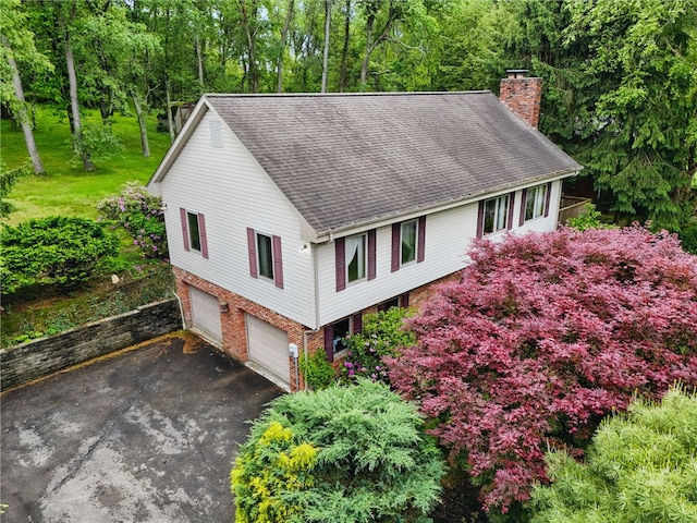 120 Canterbury Ln, Peters Twp, PA 15317 - view of front facade with a chimney, asphalt driveway, roof with shingles, a garage, and brick siding