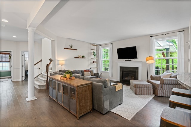 3035 Brookstone Dr, Cecil, PA 15317 - living area featuring decorative columns, plenty of natural light, a glass covered fireplace, dark wood-type flooring, and recessed lighting