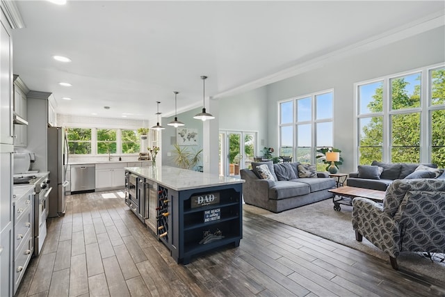 235 Valley Circle Dr, Speers Boro, PA 15022 - kitchen featuring stainless steel appliances, open floor plan, crown molding, dark wood finished floors, and a kitchen island