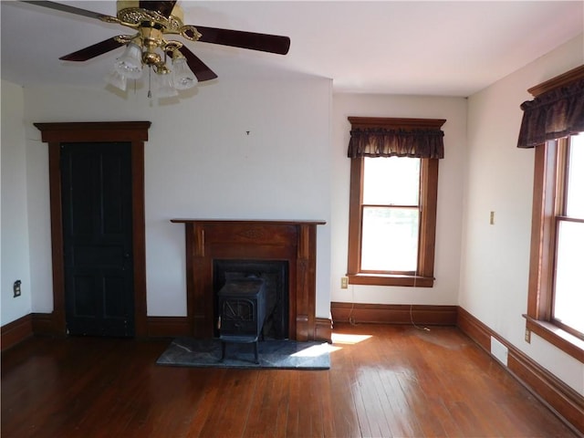 309 Mooney Ridge Rd, Waynsbrg/Frankln Twp, PA 15370 - unfurnished living room featuring a wood stove, healthy amount of natural light, hardwood / wood-style flooring, and baseboards