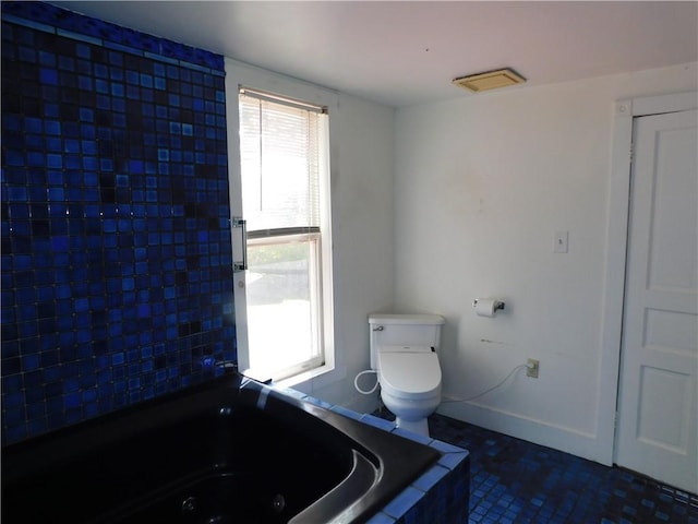 309 Mooney Ridge Rd, Waynsbrg/Frankln Twp, PA 15370 - bathroom featuring a whirlpool tub, toilet, and tile patterned flooring