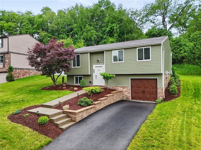 450 Limestone Dr, Bethel Park, PA 15102 - bi-level home featuring a garage, asphalt driveway, a front yard, and brick siding