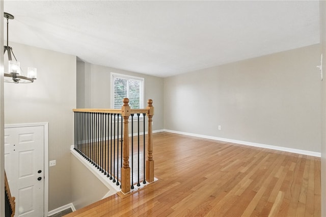 450 Limestone Dr, Bethel Park, PA 15102 - hallway featuring an upstairs landing, light wood-style flooring, baseboards, and a chandelier