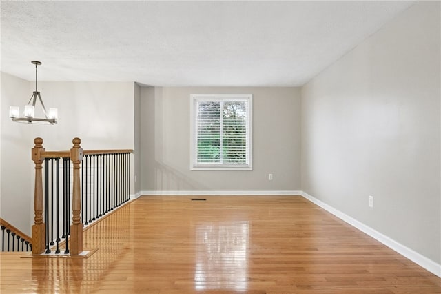 450 Limestone Dr, Bethel Park, PA 15102 - spare room featuring a chandelier, light wood-style flooring, and baseboards