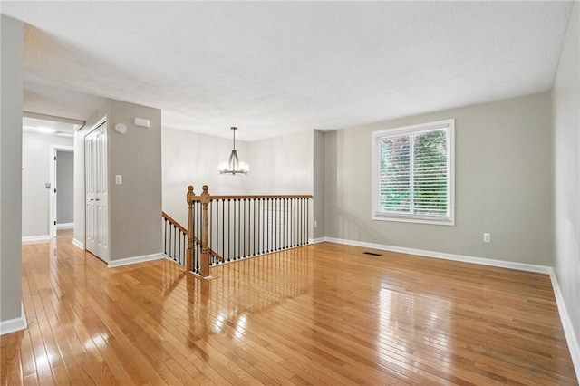 450 Limestone Dr, Bethel Park, PA 15102 - unfurnished room with hardwood / wood-style flooring, a chandelier, and baseboards