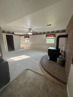 142 Poorbaugh Rd, Bullskin Twp, PA 15425 - living room featuring a wood stove and a ceiling fan