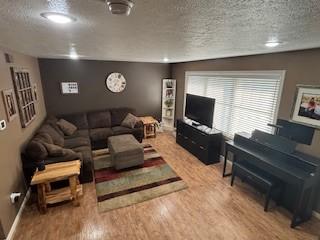 142 Poorbaugh Rd, Bullskin Twp, PA 15425 - living area with a textured ceiling, wood finished floors, and baseboards