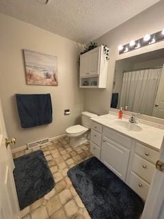 142 Poorbaugh Rd, Bullskin Twp, PA 15425 - bathroom featuring vanity, toilet, a textured ceiling, and tile patterned floors