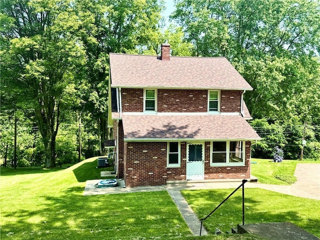4404 Hollow Rd, Shenango Twp Law, PA 16101 - view of front of property featuring a chimney, a front yard, central AC, and a shingled roof