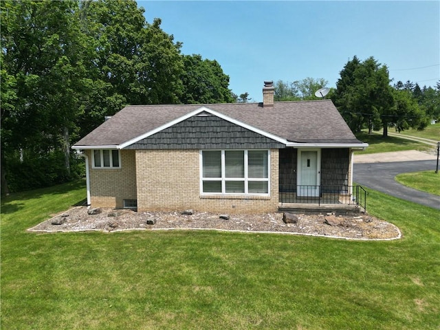 721 Herman Rd, Summit Twp But, PA 16002 - ranch-style house featuring a chimney, brick siding, a front lawn, and a shingled roof