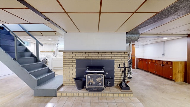 721 Herman Rd, Summit Twp But, PA 16002 - below grade area with a wood stove, washer / dryer, and stairway